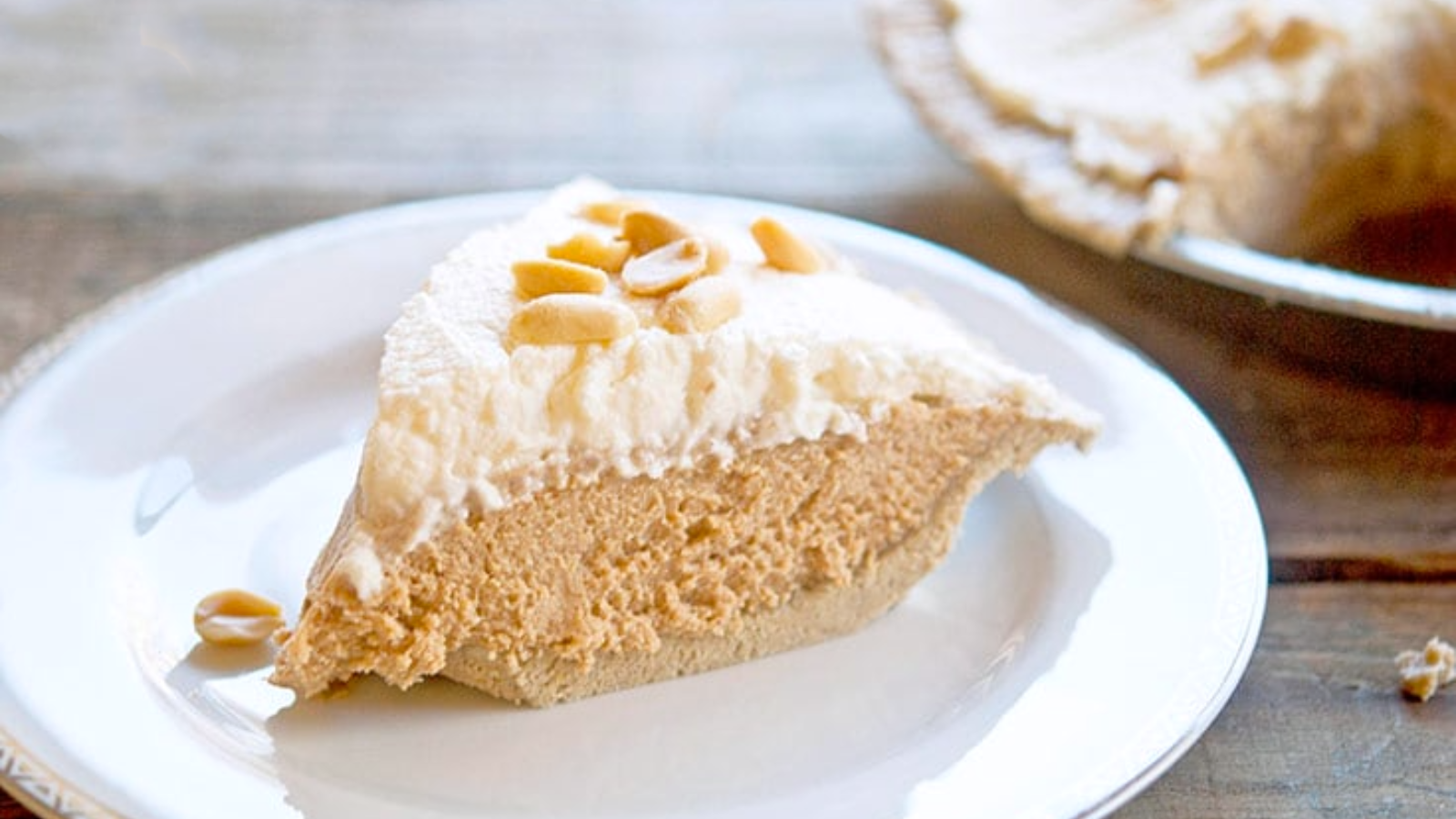 A slice of peanut butter pie on a white plate.