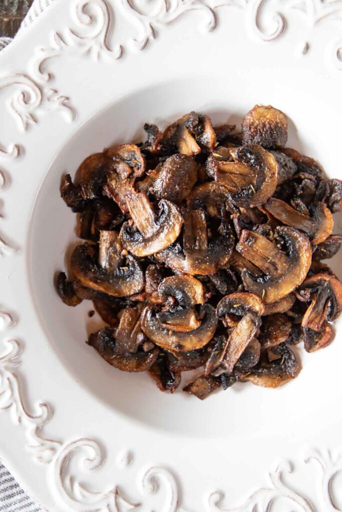 Air fryer baby bella mushrooms in a white bowl without garnish.