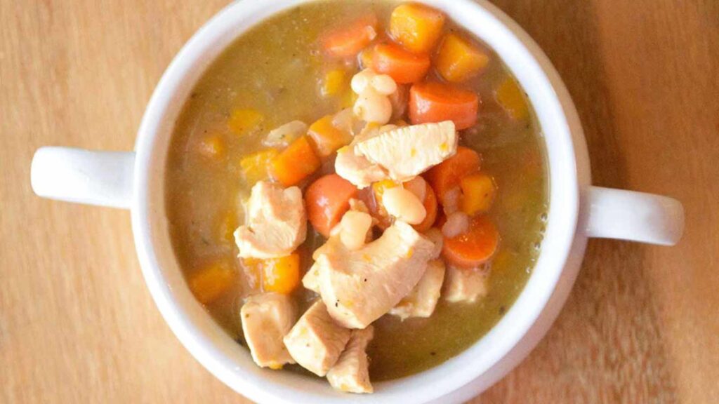 An overhead view looking down into a bowl filled with this Chicken Stew Recipe With Butternut Squash.