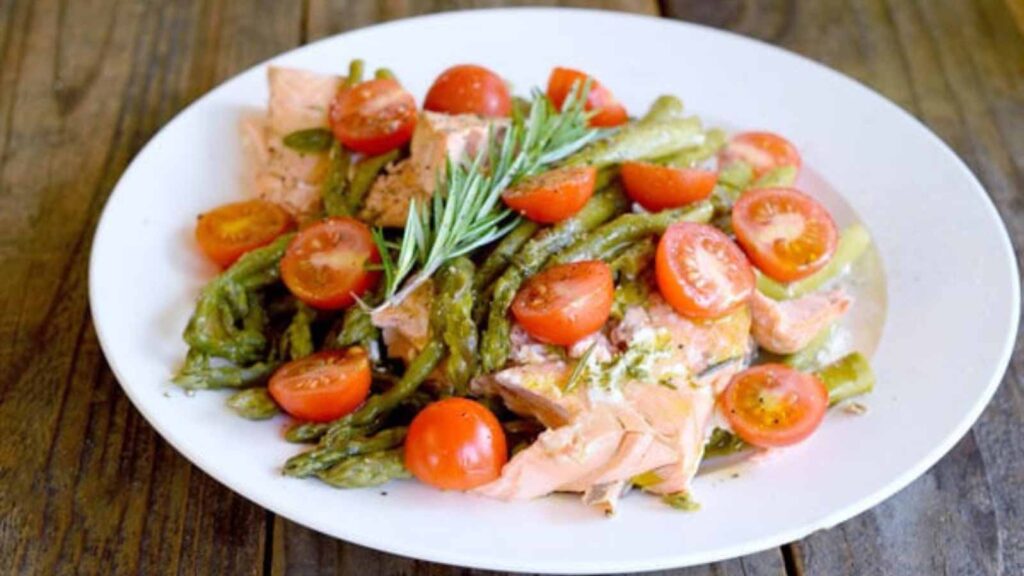 A whit plate filled with Pressure Cooker Mediterranean Salmon.