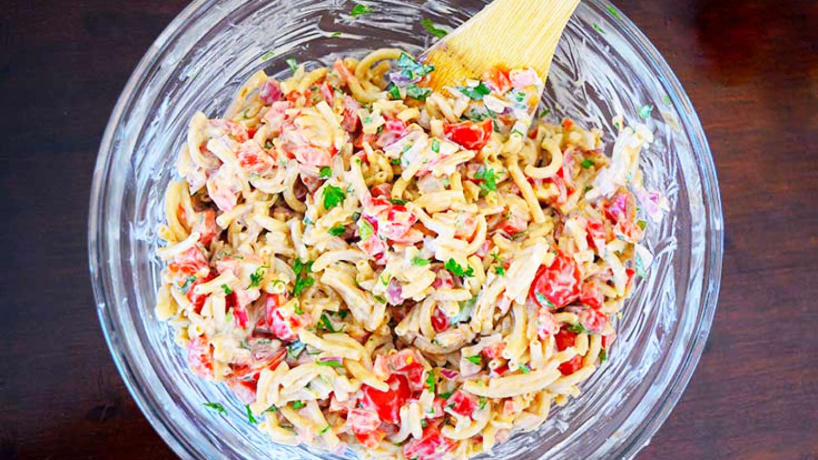 An overview shot of this easy macaroni salad recipe, looking down into the bowl at this colorful dish.