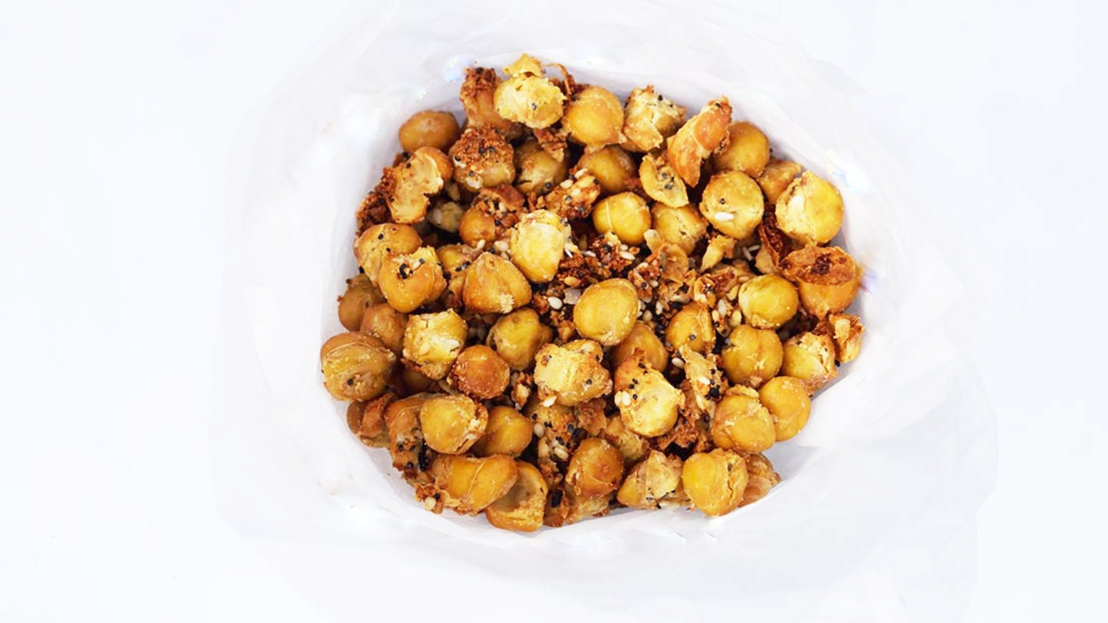 A funnel of parchment paper holds a batch of Roasted Everything Bagel Seasoning Chickpeas.
