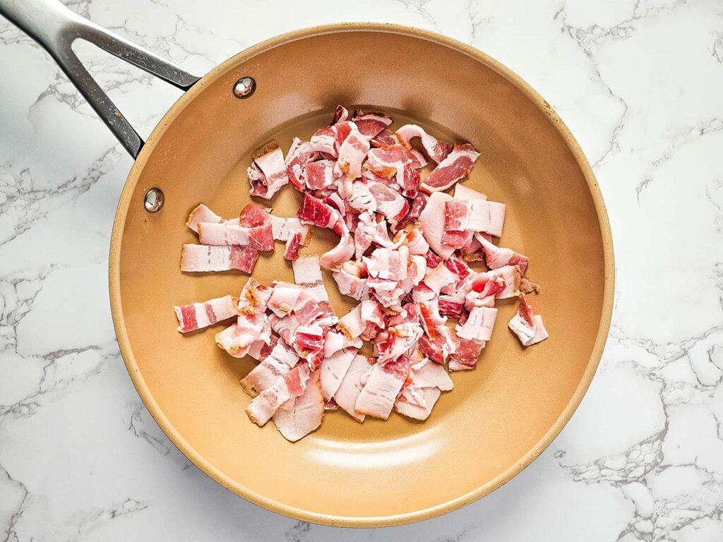 Bacon pieces in a skillet.