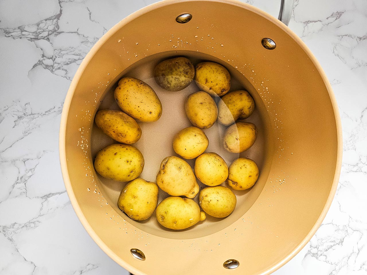 Potatoes in a pot of water.