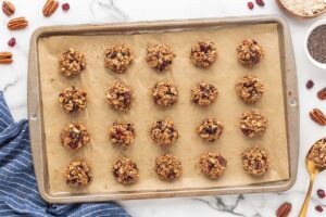 No-bake cookies spooned onto a parchment-lined cookie sheet.