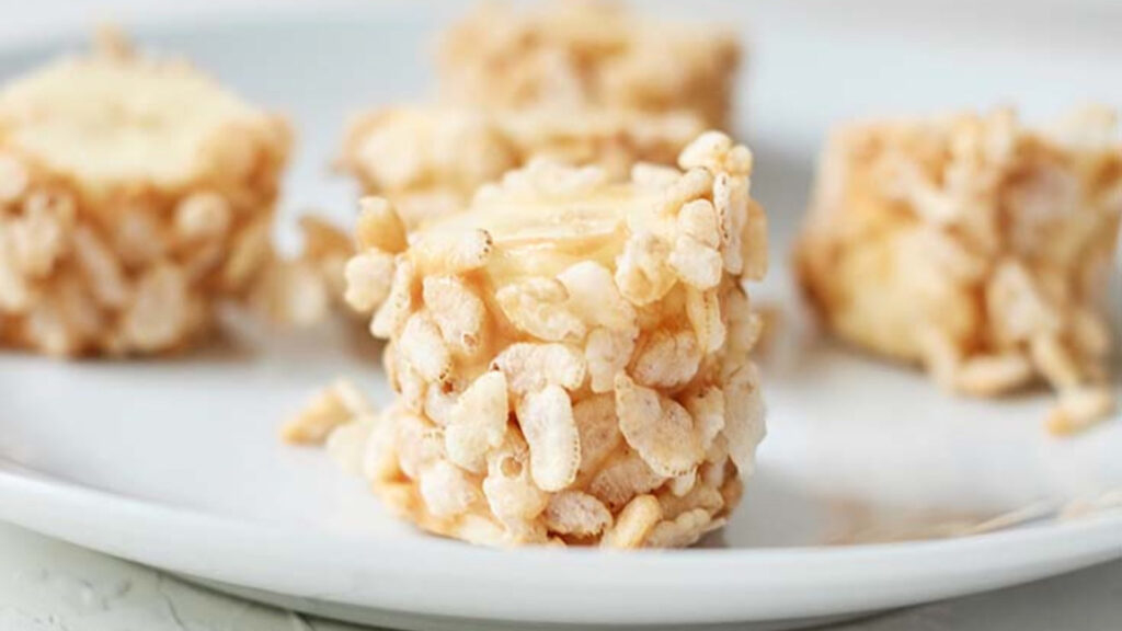 Thick slices of banana rolled in puffed cereal.