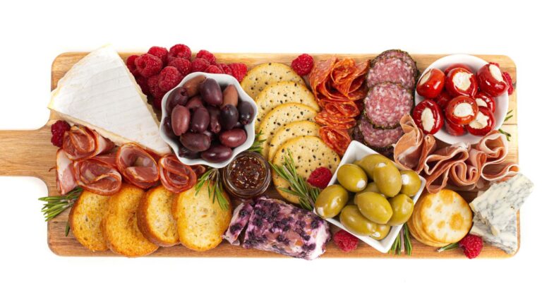 Savoury Charcuterie Board Covered in Meats Olives Peppers Berries and Cheese